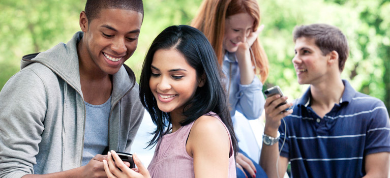 Teens interacting with smartphones