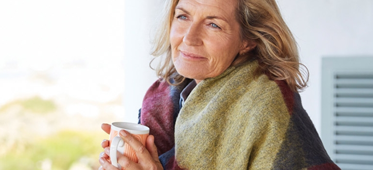 Woman drinking coffee outside