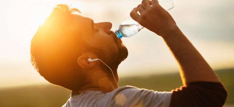 Man drinking water after exercising.