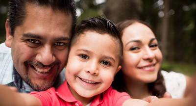 Family sitting outside in a park.